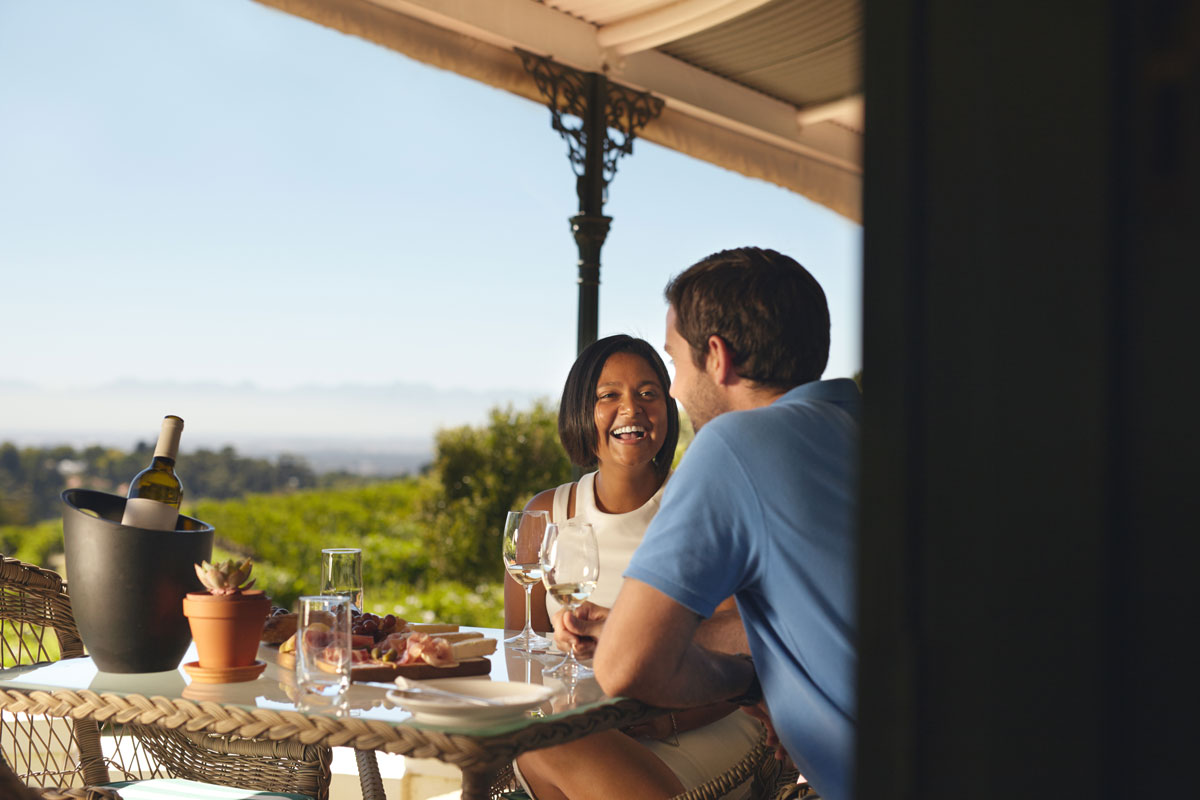 couple of people enjoying a wine tasting outside