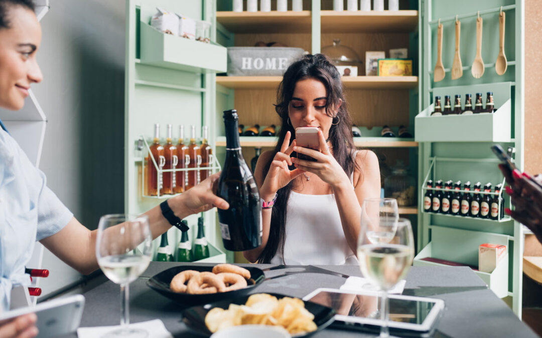 women looking up wine on her mobile device